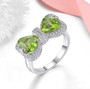 peridot and white zircon bow ring in rhodium over sterling silver shown in a lifestyle photo