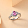 padparadscha sapphire and diamond halo ring in 950 platinum shown in a lifestyle photo