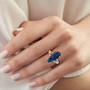 boulder opal triplet colombian emerald and diamond ring in 14k yellow gold worn on a hand