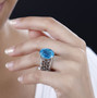 blue quartz triplet and black spinel solitaire ring in rhodium over sterling silver worn on a hand