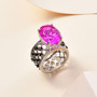 pink quartz triplet and black spinel solitaire ring in rhodium over sterling silver shown in a lifestyle photo