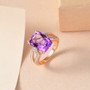 amethyst and white zircon solitaire ring in 18k rose gold over sterling silver shown in a lifestyle photo