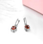 full view of sugar-loaf cut hessonite garnet dangle earrings in rhodium over sterling silver