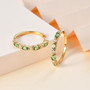 tsavorite garnet and moissanite hoop earrings in 18k yellow gold over sterling silver shown in a lifestyle photo