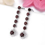 garnet and white zircon drop earrings in rhodium over sterling silver shown in a lifestyle photo