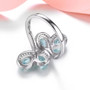 back view of aquamarine and white zircon bypass ring in rhodium over sterling silver