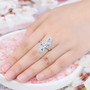 aquamarine and white zircon bypass ring in rhodium over sterling silver worn on a hand