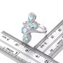 aquamarine and white zircon bypass ring in rhodium over sterling silver shown for size comparison