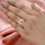 morganite pink and white diamond cushion halo ring in solid 14k rose and white gold worn on a hand