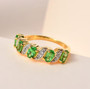tsavorite garnet and white zircon band ring in 18k yellow gold over sterling silver shown in a lifestyle photo