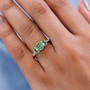 tsavorite garnet and yellow diamond trilogy ring in 10k yellow gold worn on a hand