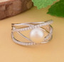 white freshwater pearl and cz crossover band ring in rhodium over sterling silver shown in a lifestyle photo