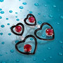 lab ruby and white cz black enamel heart earrings in rhodium over sterling silver shown in a lifestyle photo