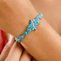 turquoise and moissanite bracelet in rhodium over sterling silver worn on a wrist