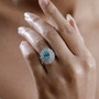 paraiba tourmaline and diamond triple halo ring in solid 950 platinum worn on a hand