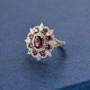 rhodolite garnet and moissanite halo ring in rhodium over sterling silver shown in a lifestyle photo