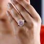 pink spinel and moissanite double halo ring in 18k rose gold over sterling silver worn on a hand