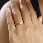 yellow sapphire and diamond halo ring in 14k yellow gold worn on a hand