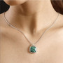 malachite and white zircon pendant necklace in two-tone 18k yellow gold and rhodium over sterling silver worn around the neck