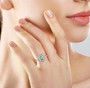tsavorite garnet padparadscha sapphire and diamond halo ring in solid 950 platinum worn on a hand