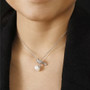 freshwater pearl and moissanite bird pendant necklace in rhodium over sterling silver worn around the neck