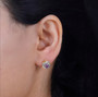 amethyst and white zircon love knot earrings in 18k yellow gold and rhodium over sterling silver worn on the ear