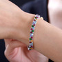 multi gemstone tennis bracelet in rhodium over sterling silver worn on a wrist