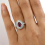 garnet blue apatite and zircon halo ring in rhodium over sterling silver worn on a hand