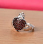 garnet heart cluster claddagh ring in rhodium over sterling silver shown in a lifestyle photo