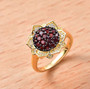 garnet and white zircon cluster ring in 18k yellow gold over sterling silver shown in a lifestyle photo