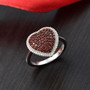 garnet and white zircon heart cluster ring in rhodium over sterling silver shown in a lifestyle photo