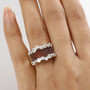garnet and white zircon cluster band ring in rhodium over sterling silver worn on a hand