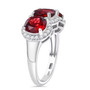 side view of round garnet and white zircon trilogy ring in rhodium over sterling silver