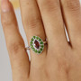 garnet and chrome diopside halo ring in rhodium over sterling silver worn on a hand