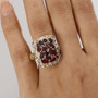 garnet and white zircon ring in 18k yellow gold and rhodium over sterling silver worn on a hand