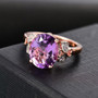 amethyst and white zircon ring in 18k rose gold over sterling silver shown in a lifestyle photo