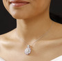 moissanite and pink sapphire pendant necklace in rhodium over sterling silver worn around the neck