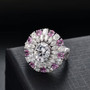 moissanite and pink sapphire halo ring in rhodium over sterling silver shown in a lifestyle photo
