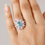 blue apatite moissanite and pink sapphire ring in rhodium over sterling silver worn on a hand