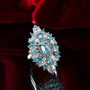 blue apatite and white zircon elongated statement ring in rhodium over sterling silver shown in a lifestyle photo