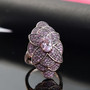 kunzite and pink sapphire elongated cocktail ring in 18k rose gold over sterling silver shown in a lifestyle photo
