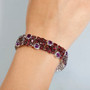 rhodolite garnet and amethyst tennis bracelet in rhodium over sterling silver worn on a wrist