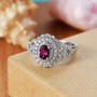 rhodolite garnet and moissanite ring in rhodium over sterling silver shown in a lifestyle photo