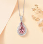 pink apatite pink sapphire and white zircon halo pendant necklace in rhodium over sterling silver shown in a lifestyle photo