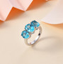 blue apatite oval trilogy ring in solid 10k white gold shown in a lifestyle photo