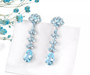 full view of sky blue topaz flowering dangle earrings in rhodium over sterling silver