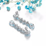 sky blue topaz flowering dangle earrings in rhodium over sterling silver