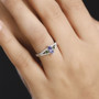 tanzanite chrome diopside and moissanite three stone ring in rhodium over sterling silver worn on a hand