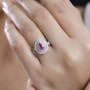 padparadscha sapphire and diamond halo ring in 950 platinum worn on a hand