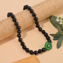 green jade peach freshwater pearl and shungite beaded necklace in rhodium over sterling silver shown in a lifestyle photo